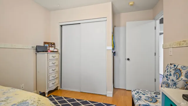 a bedroom with a bed and a dresser in it