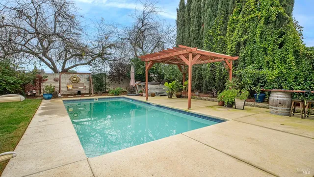 a swimming pool with outdoor seating yard and green space