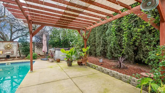 a view of a patio with table and chairs and potted plants