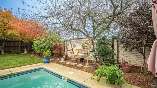 a view of a backyard with sitting area