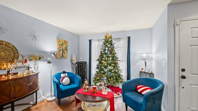 a living room with furniture and flowers