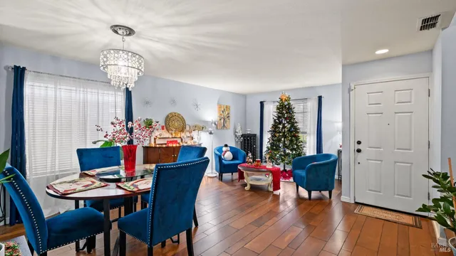 a view of a dining room with furniture wooden floor and chandelier
