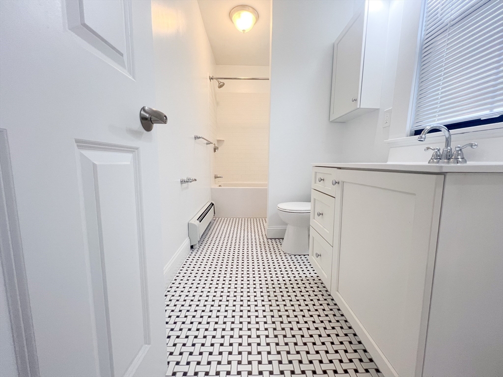 219 Commonwealth Avenue, Unit 12 Newton, MA 02467 - Photo 5 of 12 a bathroom with a sink toilet and shower