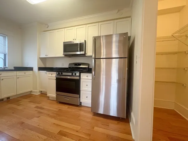 a kitchen with a refrigerator stove and microwave
