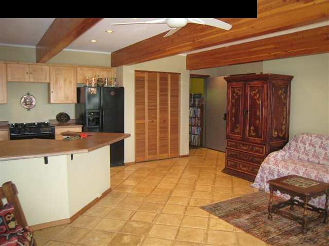 980 East Kuiaha Road Haiku, HI 96708 - Photo 12 of 25 a spacious bedroom with a bed and a dresser in it