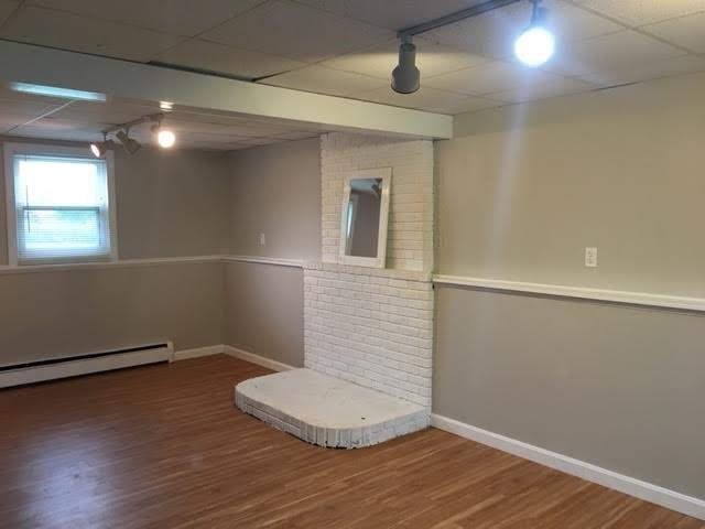 157 Guinea Road Biddeford, ME 04005 - Photo 24 of 27 Family room with raised hearth. Wood...