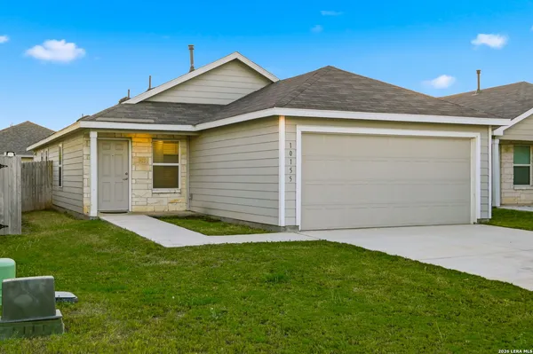 a front view of house with yard and garage