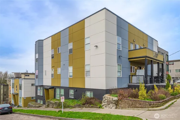 a aerial view of a house with a yard and balcony