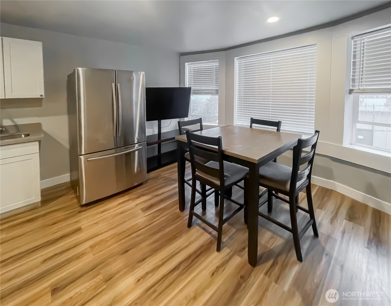 1815 13th Avenue South Seattle, WA 98144 - Photo 12 of 18 a view of a dining room with furniture a refrigerator and wooden floor