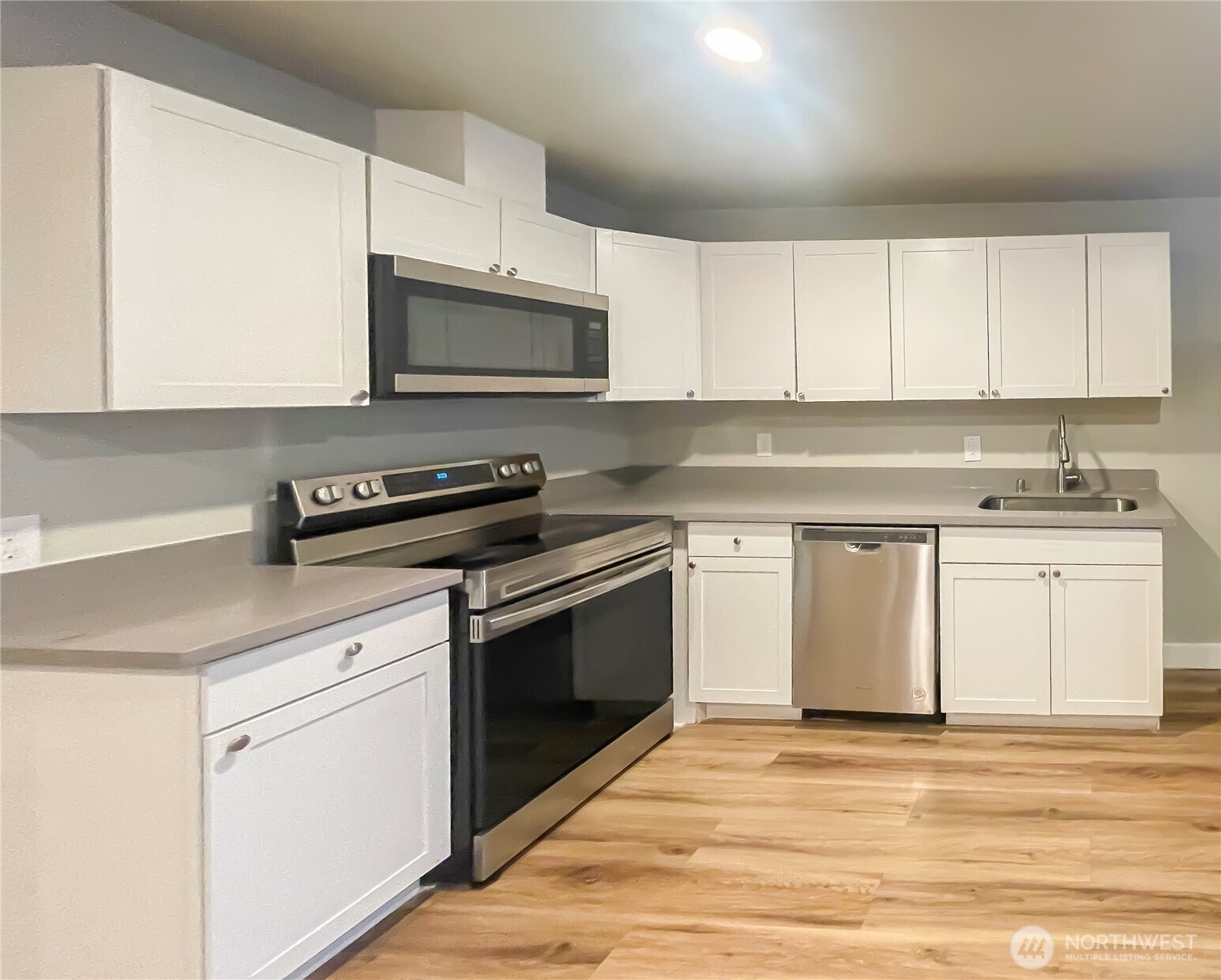 1815 13th Avenue South Seattle, WA 98144 - Photo 15 of 18 a kitchen with stainless steel appliances granite countertop a sink a stove and a microwave