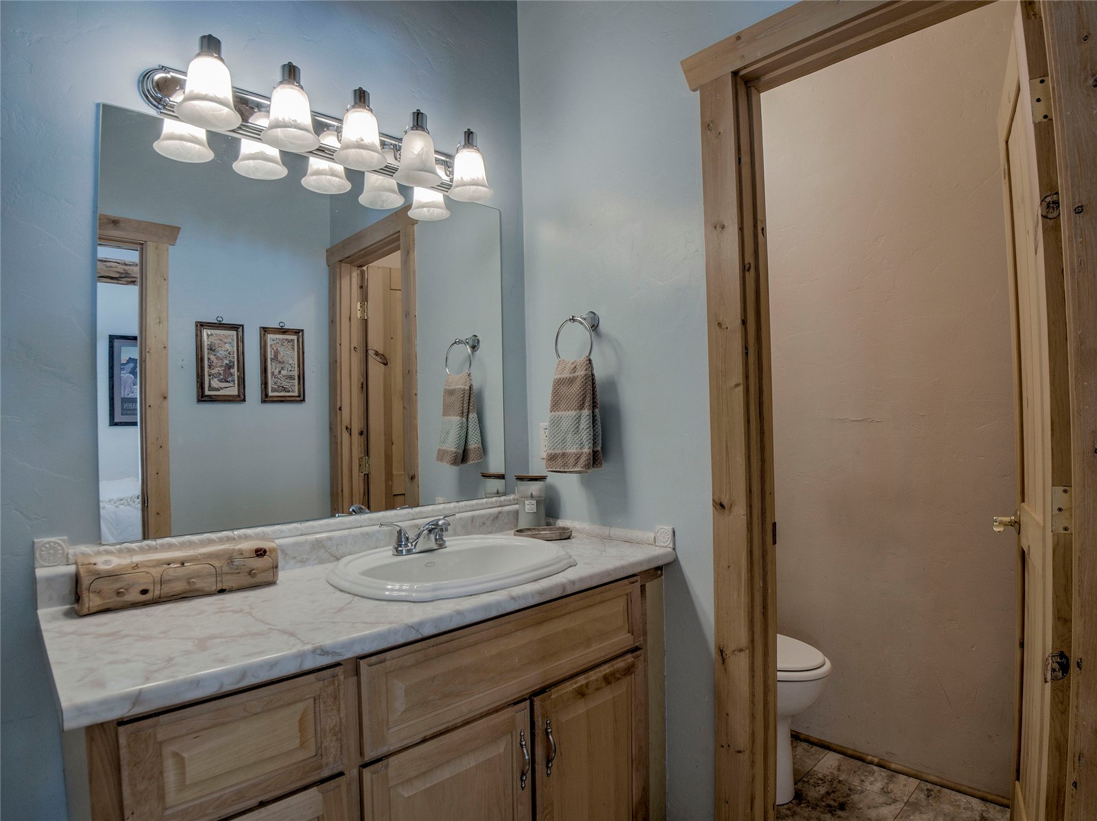 46 Singleton Road Alma, CO 80420 - Photo 19 of 50 a bathroom with a granite countertop sink a toilet and a mirror