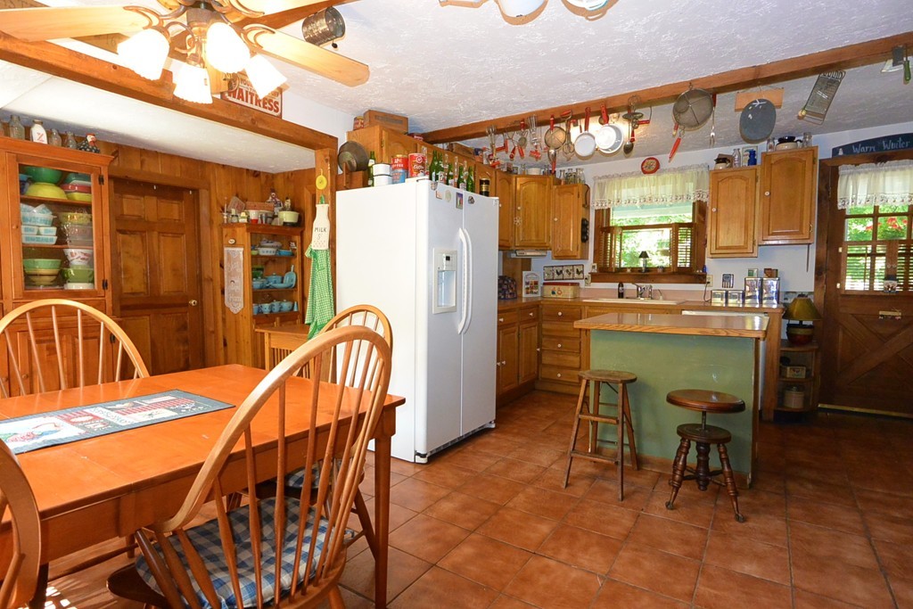 217 Old Common Road Lancaster, MA 01523 - Photo 8 of 22 a dining room with furniture and a chandelier