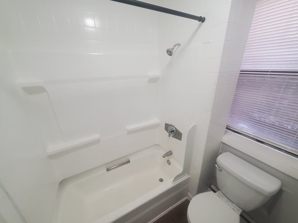 620 Dudley Street, Unit 4 Boston, MA 02125 - Photo 11 of 14 a bathroom with a toilet and a shower