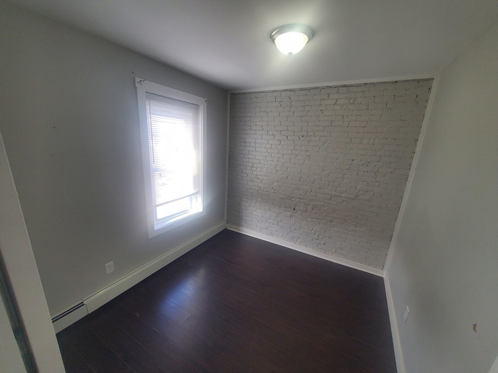 620 Dudley Street, Unit 4 Boston, MA 02125 - Photo 5 of 14 an empty room with a window