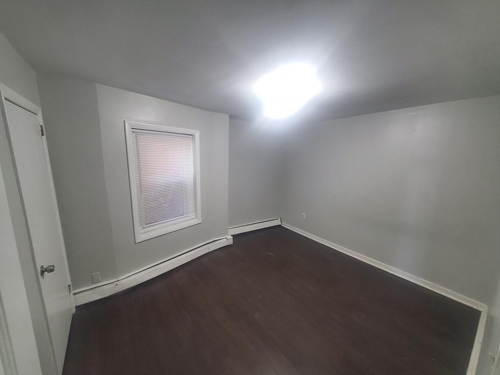 620 Dudley Street, Unit 4 Boston, MA 02125 - Photo 7 of 14 an empty room with a window