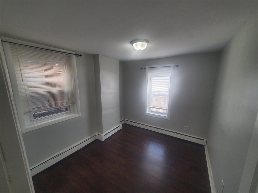 620 Dudley Street, Unit 4 Boston, MA 02125 - Photo 8 of 14 a view of room window and wooden floor