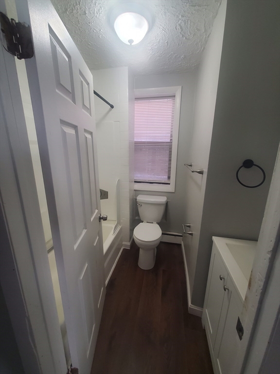 620 Dudley Street, Unit 4 Boston, MA 02125 - Photo 10 of 14 a bathroom with a toilet sink and a mirror