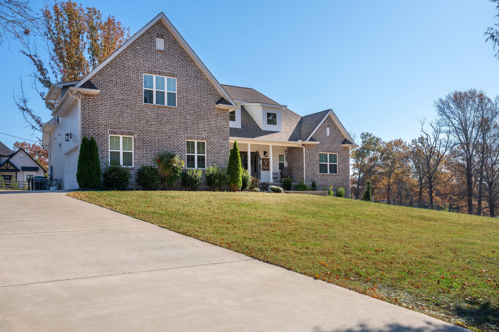 a front view of a house with yard and green space