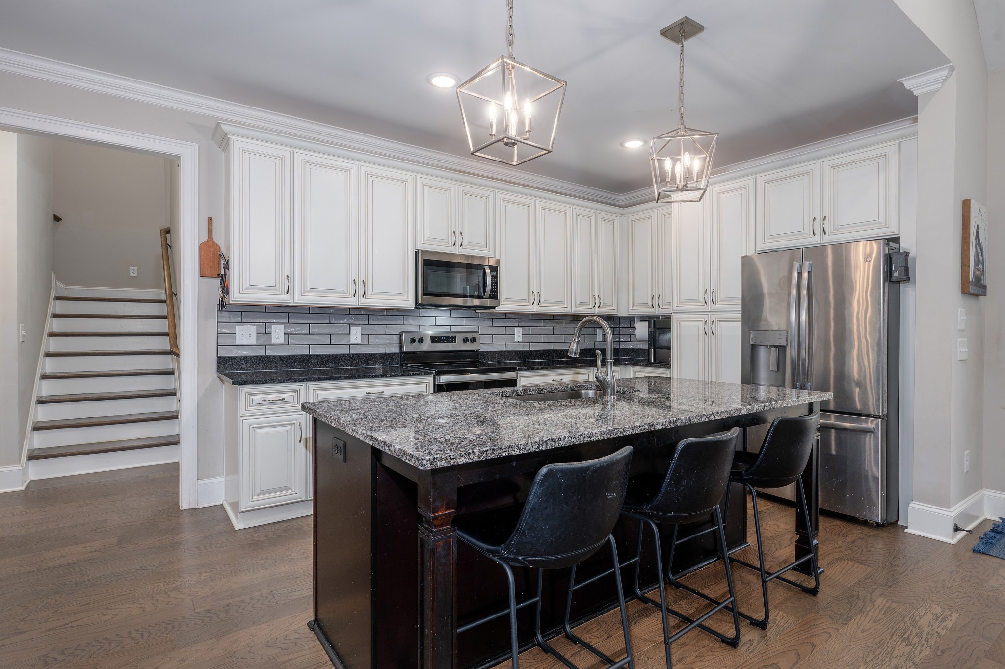 1835 Belotes Ferry Road Lebanon, TN 37087 - Photo 4 of 40 a kitchen with kitchen island granite countertop a center island a refrigerator cabinets and wooden floor