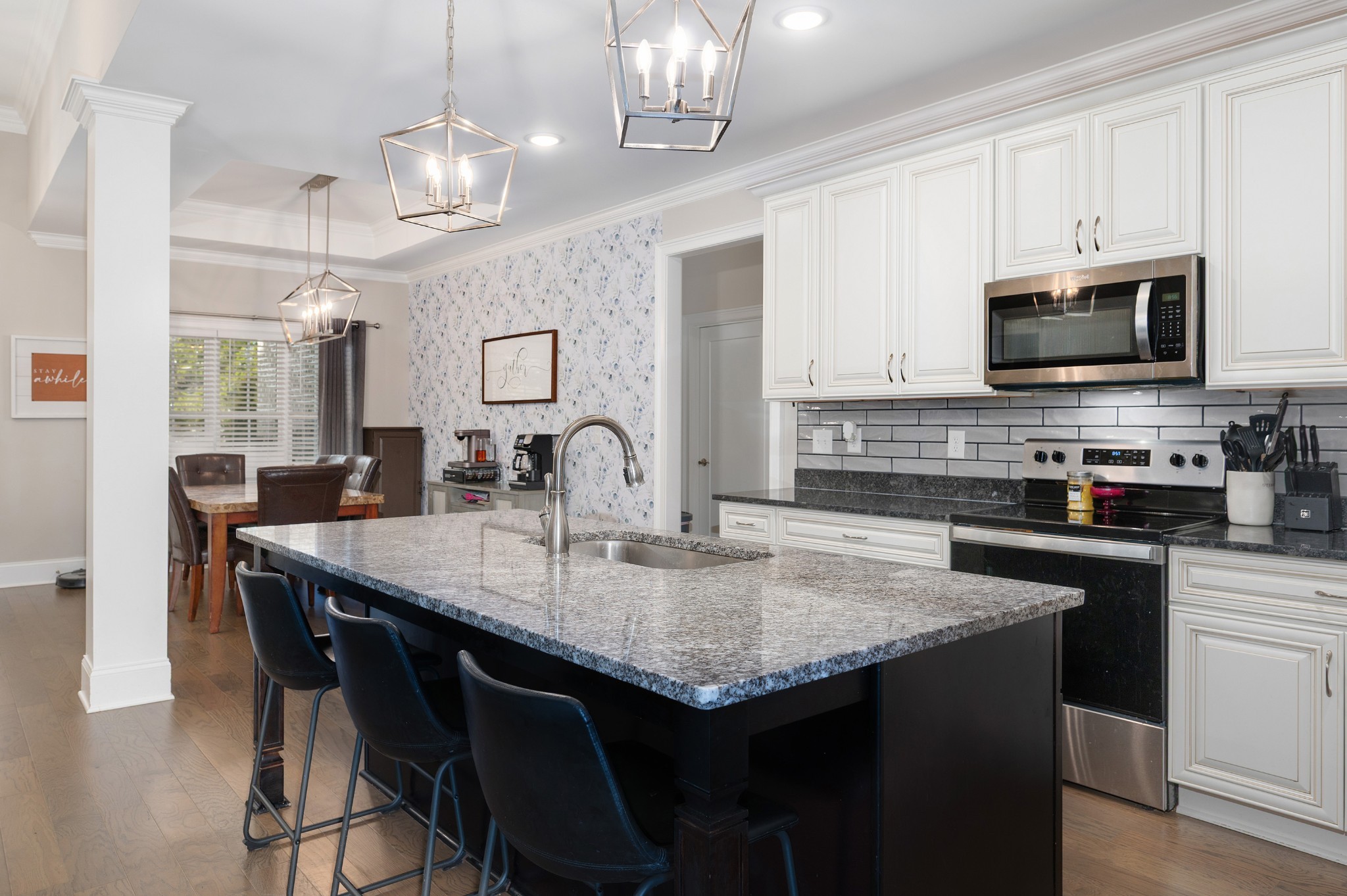 1835 Belotes Ferry Road Lebanon, TN 37087 - Photo 5 of 40 a kitchen with stainless steel appliances granite countertop a kitchen island a stove a table and chairs in it