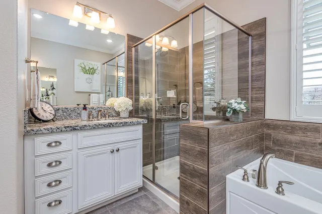 a bathroom with a granite countertop toilet sink and a mirror