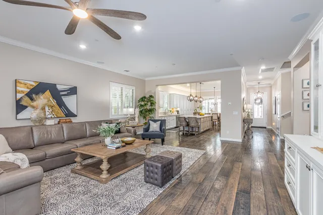 a kitchen with a dining table chairs and chandelier
