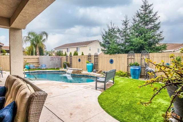 a view of swimming pool with outdoor seating and plants