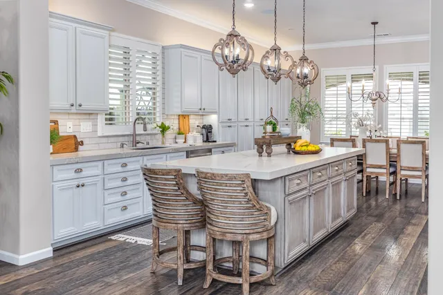 a kitchen with stainless steel appliances granite countertop a stove and a refrigerator