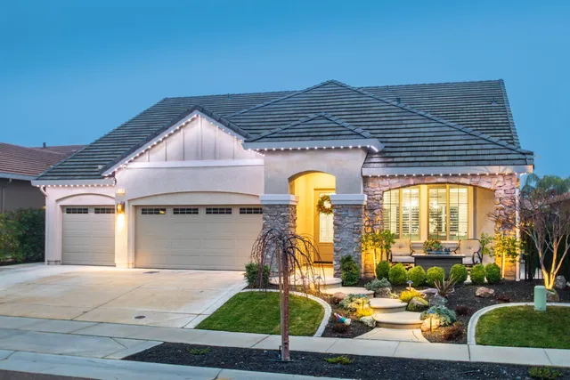 a front view of a house with garden