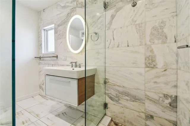 a view of a patio with couches table and chairs and potted plants
