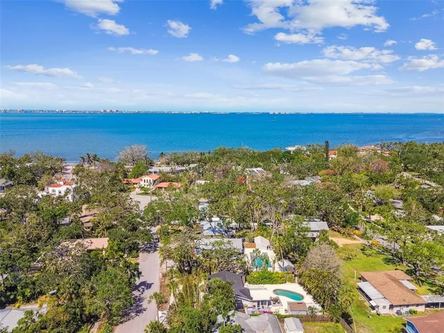a spacious bathroom with a double vanity sink a toilet and a large mirror