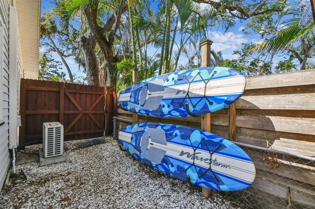 a kitchen with stainless steel appliances granite countertop a refrigerator a sink dishwasher a stove and a dining table with wooden floor