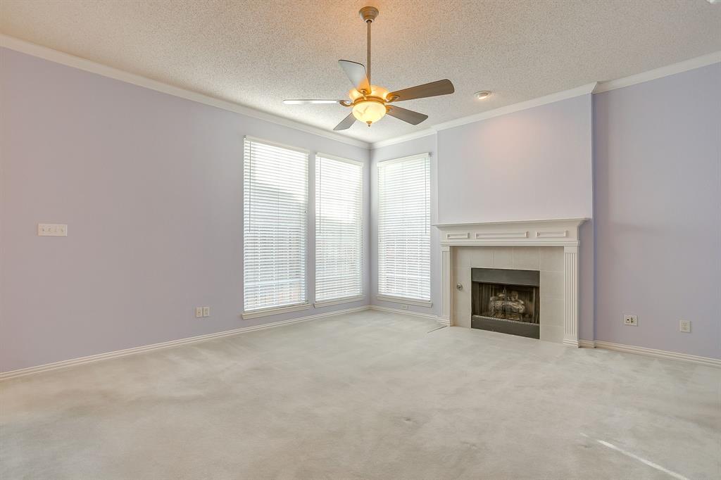 8105 Hosta Way Fort Worth, TX 76123 - Photo 14 of 33 a view of a livingroom with a fireplace and a chandelier fan