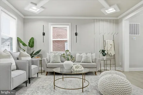 a living room with furniture a table and a potted plant