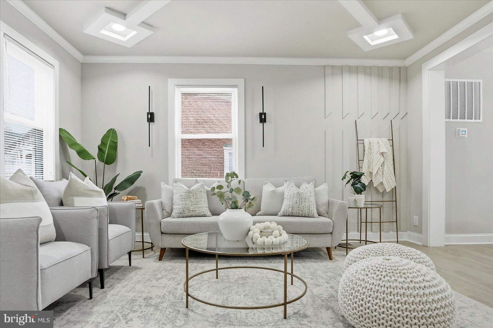 a living room with furniture a table and a potted plant