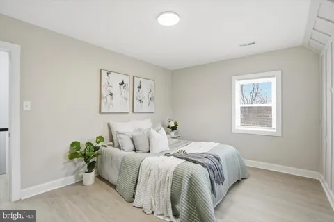 a bed room with a bed and a painting on the wall