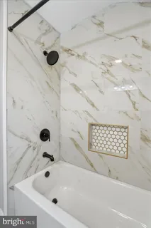 a bathroom with a bathtub and shower