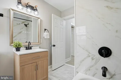 a bathroom with a sink a vanity and a mirror
