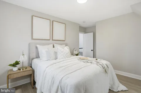 a bedroom with bed and a couch