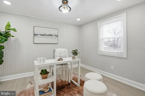 a view of a workspace with furniture and window