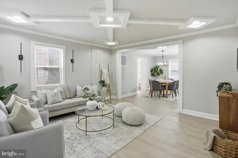 a living room with furniture a rug and a chandelier