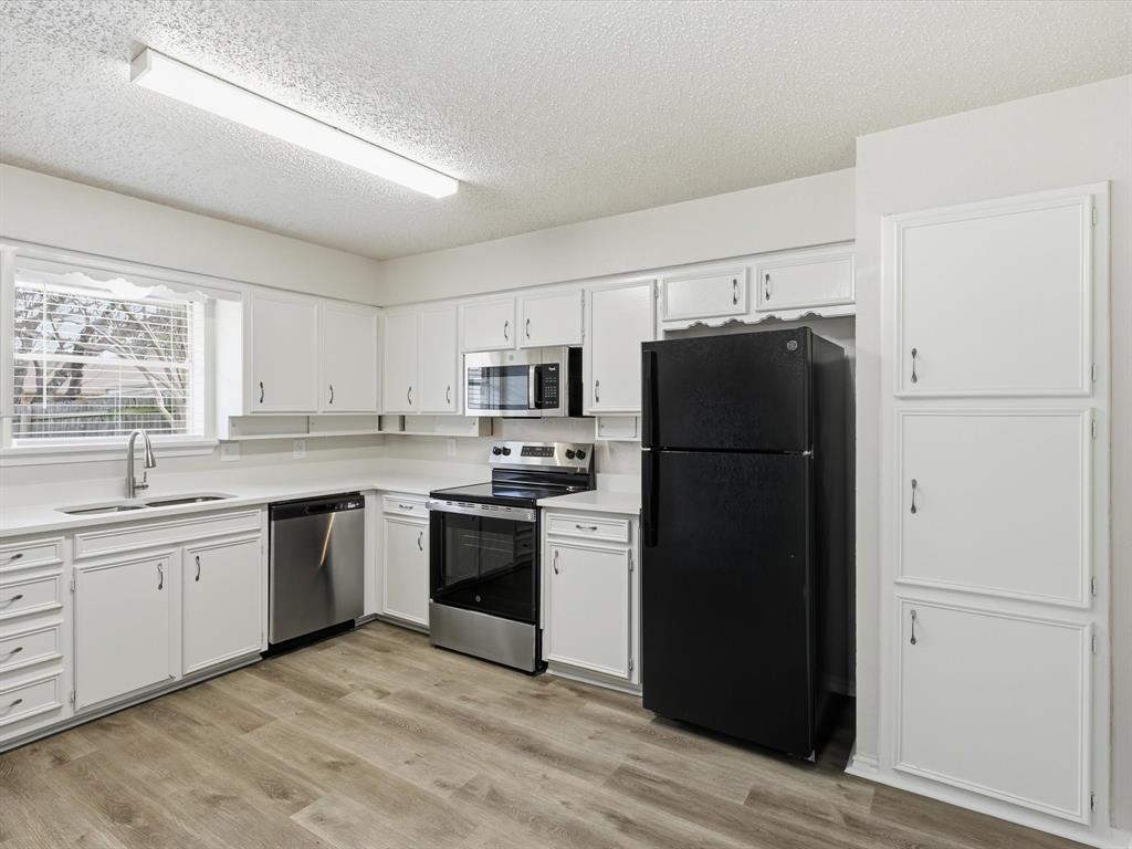 625 Reno Street Lewisville, TX 75077 - Photo 16 of 25 a kitchen with a refrigerator stove and sink