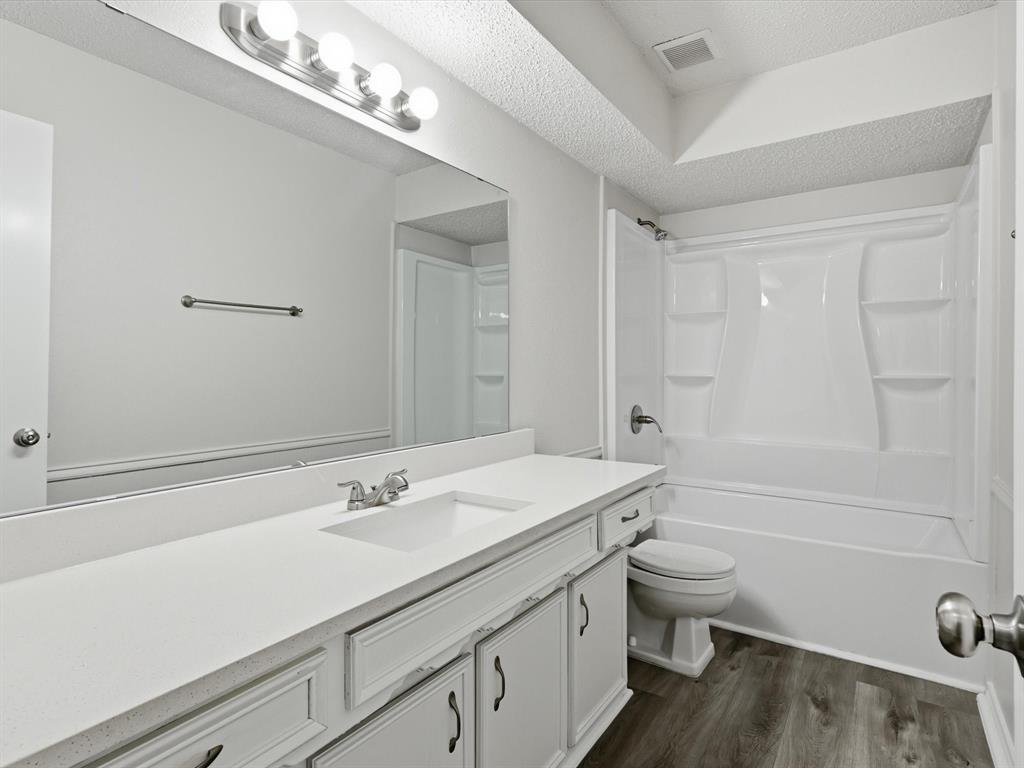 625 Reno Street Lewisville, TX 75077 - Photo 20 of 25 a bathroom with a sink a toilet and shower