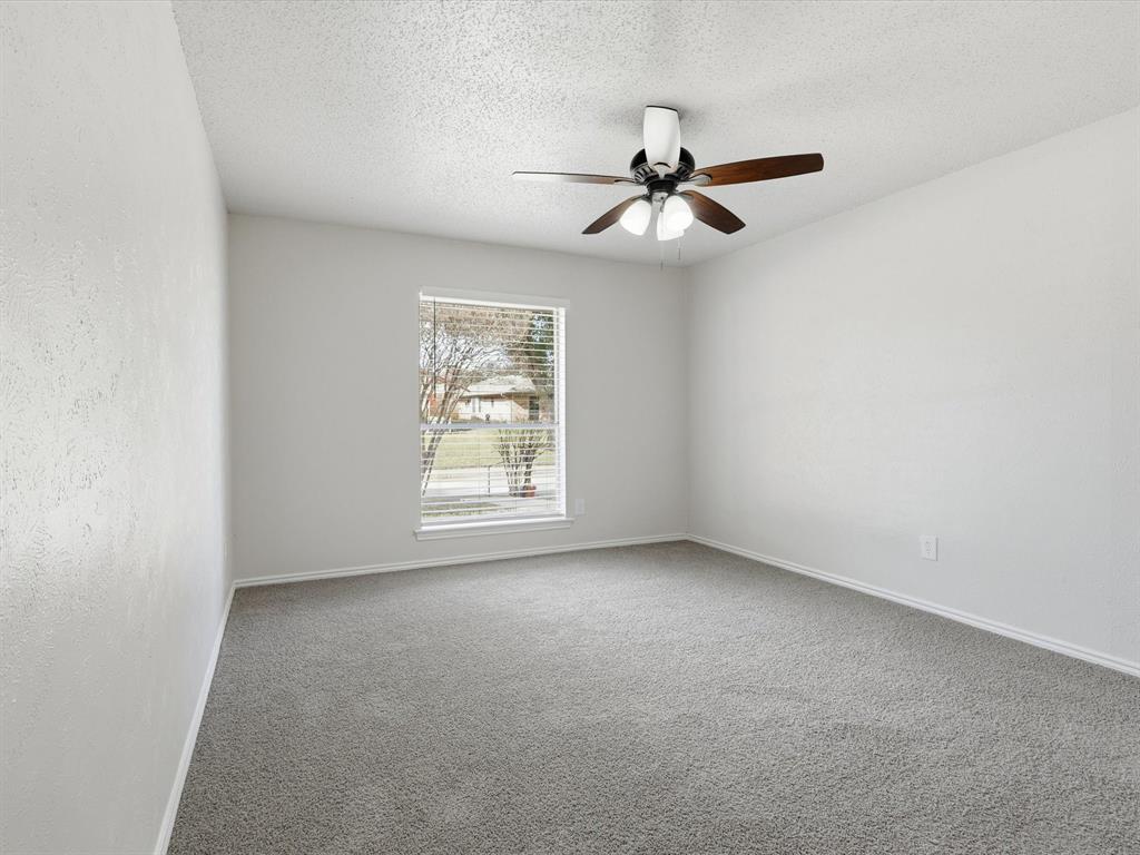 625 Reno Street Lewisville, TX 75077 - Photo 7 of 25 an empty room with windows and fan