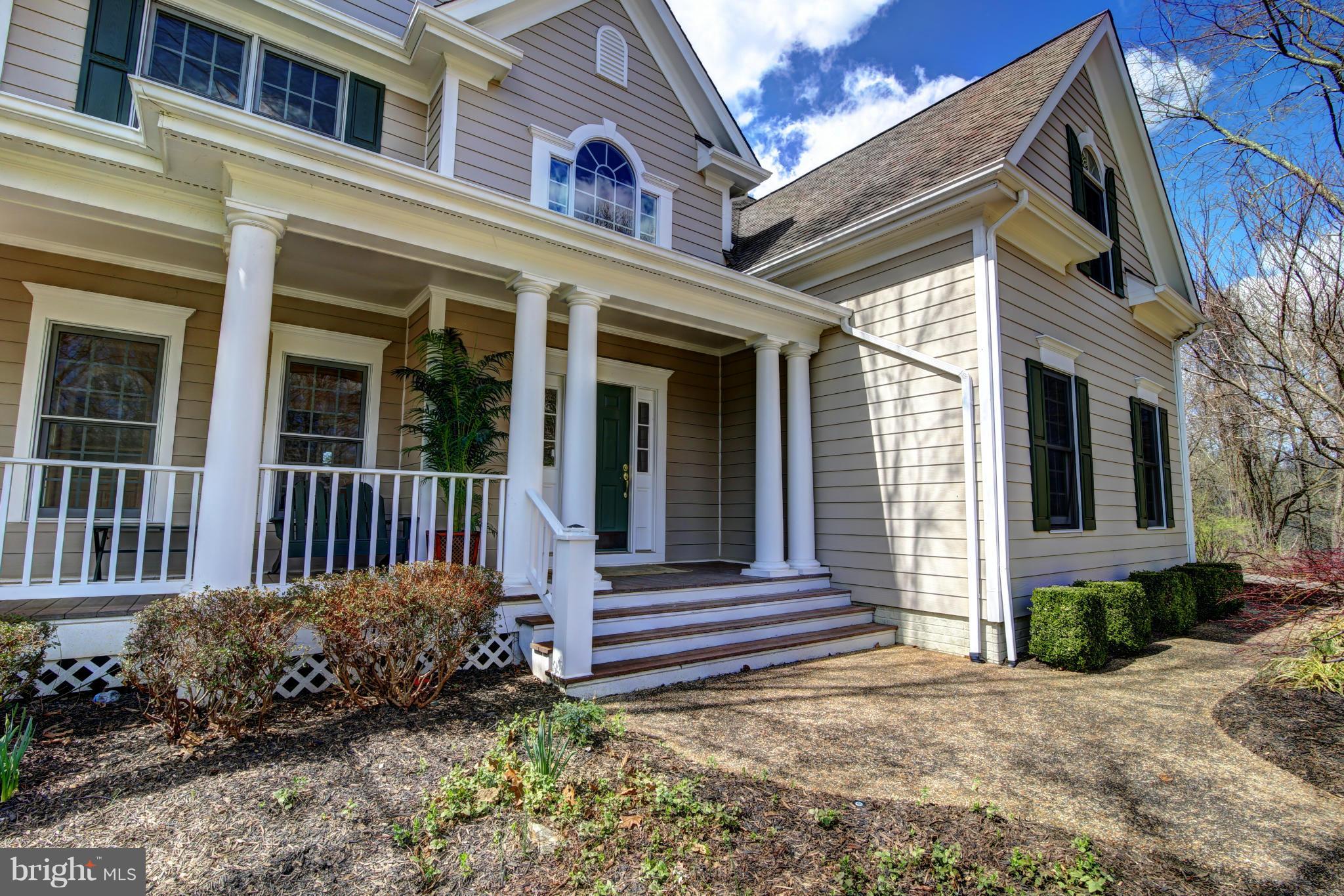 38990 Lime Kiln Road Leesburg, VA 20175 - Photo 3 of 30 a view of a house with a small yard and flower plants