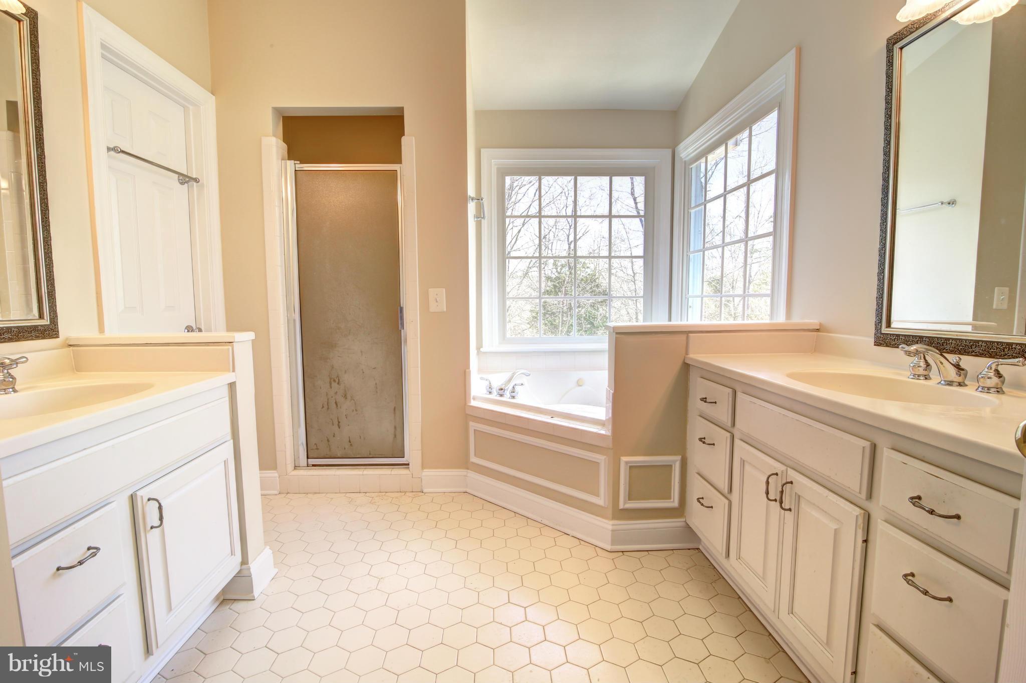 38990 Lime Kiln Road Leesburg, VA 20175 - Photo 22 of 30 a spacious bathroom with a double vanity sink a mirror and a bathtub