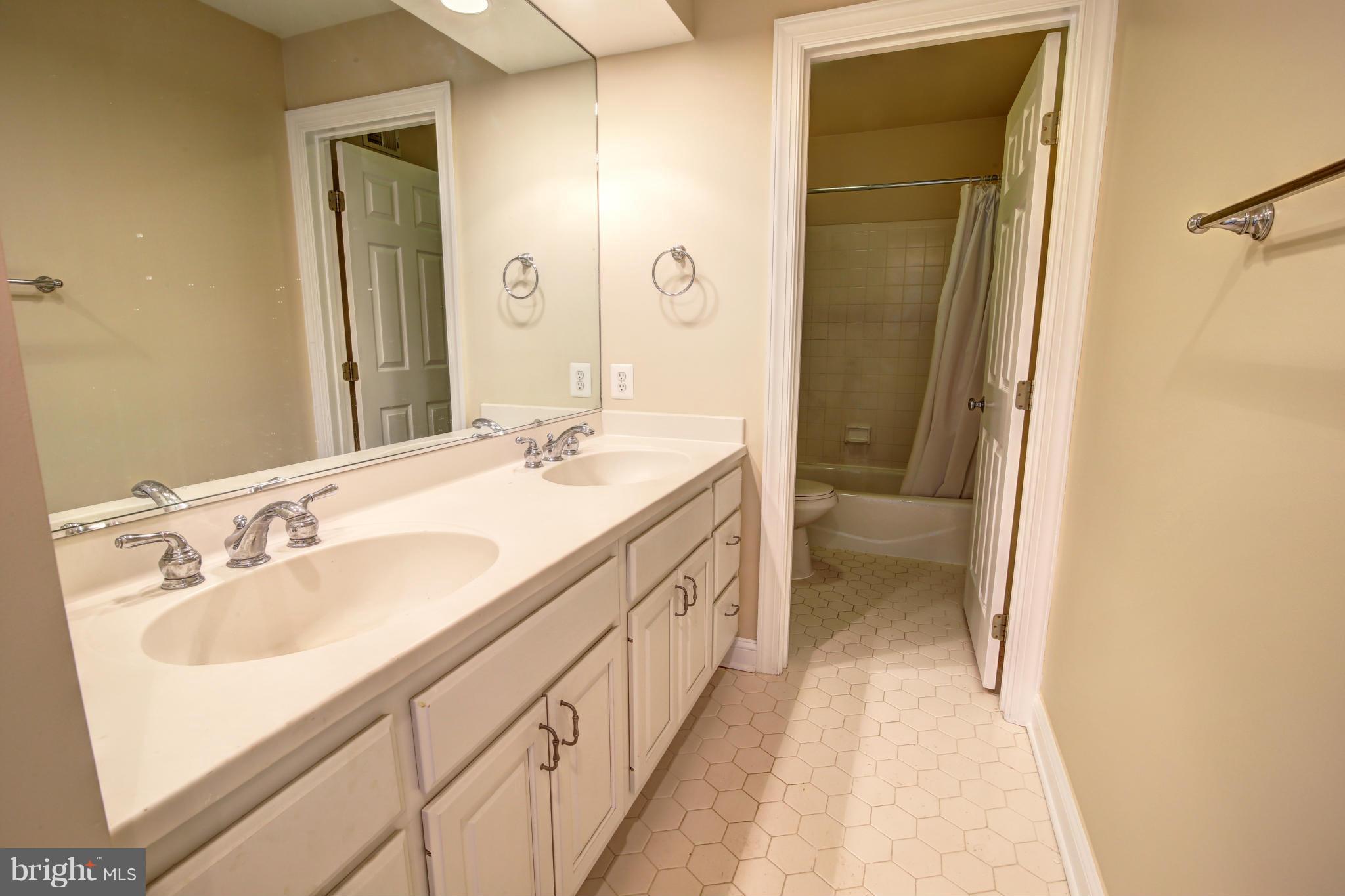 38990 Lime Kiln Road Leesburg, VA 20175 - Photo 23 of 30 a spacious bathroom with a double vanity sink and a mirror