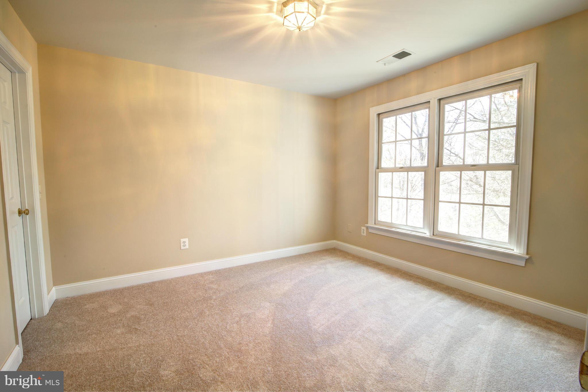 38990 Lime Kiln Road Leesburg, VA 20175 - Photo 25 of 30 an empty room with a window and a chandelier fan