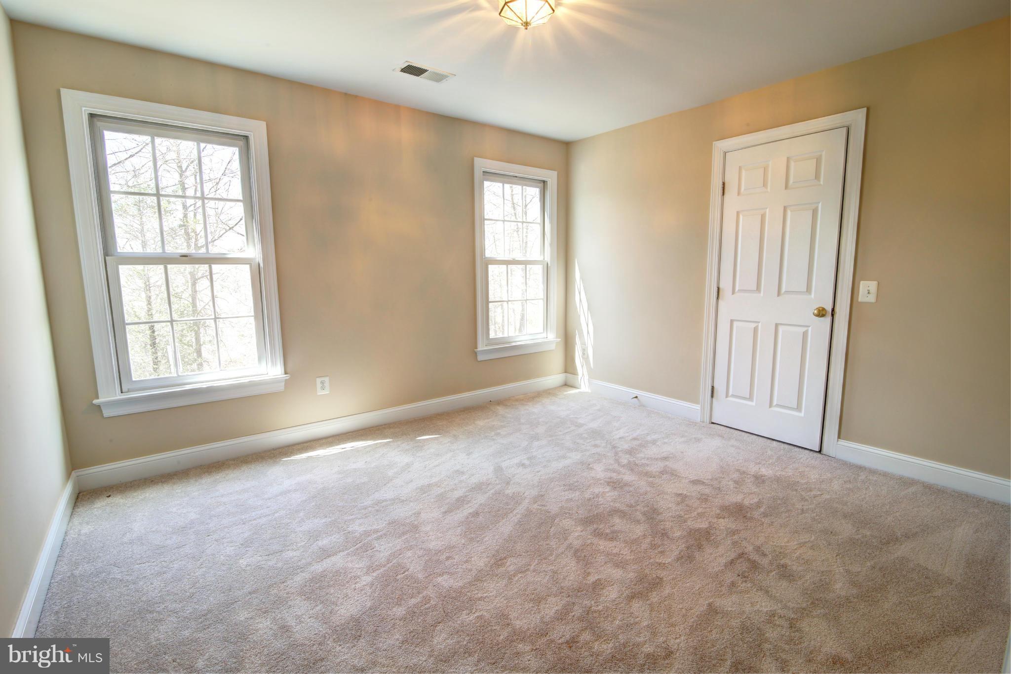 38990 Lime Kiln Road Leesburg, VA 20175 - Photo 26 of 30 an empty room with windows and chandelier fan