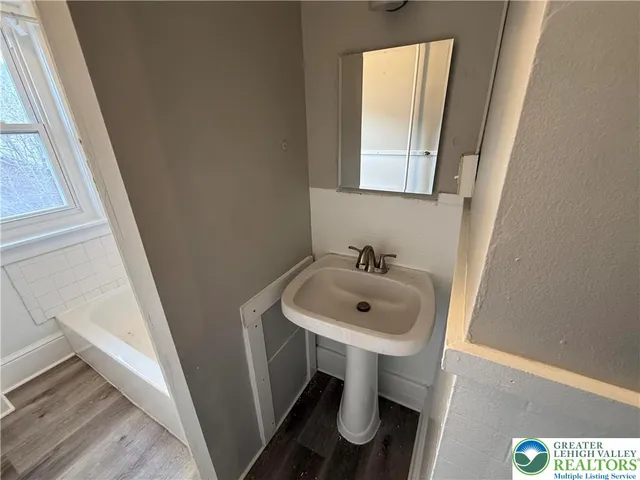 a bathroom with a sink and a mirror